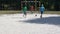 Children playing football outdoors, goal keeper hitting ball, summer activity