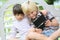 Children playing with games on outdoor bench