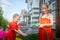 Children playing with garden sprinkler. Brother and sister running and jumping. Summer outdoor water fun in backyard