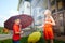 Children playing with garden sprinkler. Brother and sister running and jumping. Summer outdoor water fun in backyard