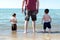 Children playing with grandpa on a Indiana beach