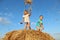Children playing with a hay, a wheat straw on a haystack
