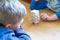 Children are playing jenga, a wood blocks tower game for practicing their physical and mental skill.two boys playng Jenga