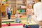 Nursery babies play on floor with carers or mothers in day care centre