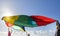 Children playing with multicolored windbreak on the beach.