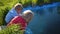 Children playing in the park near the pond. Summer sunny day