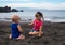 Children playing on the Playa la Arena black volcanic sand beach