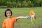 Children playing rainbow pinwheel or windmill on nature, happy kids smiling and funny on pinwheel and windy on rice field