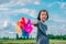 Children playing rainbow pinwheel or windmill on nature, happy kids smiling and funny on pinwheel and windy on rice field