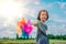 Children playing rainbow pinwheel or windmill on nature, happy kids smiling and funny on pinwheel and windy on rice field