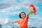 Children playing rainbow pinwheel or windmill on nature, happy kids smiling and funny on pinwheel and windy on rice field