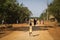 Children playing and running in dusty street