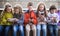 Children playing in smartphones on street bench in park