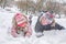 Children are playing snowballs lying in the snow, a close-up
