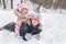 Children are playing snowballs in a sunny winter day. Childrens holidays