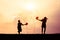 Children playing splash water Songkran silhouette.