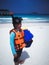 Children playing summer outdoor on beach. Snorkeling attire.