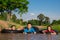 Children playing and swimming in canal of organic farm agriculture in rural