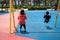 Children playing swing on playground. Kids play outdoor on sunny day