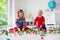 Children playing with toy railroad and train