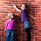 Children posing against break wall