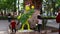 Children posing with a figure of the Grinch while their mother takes photos of them