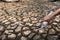 Children pour water on the arid ground.