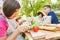 Children prepare salad in the summer camp cooking class