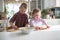 Children preparing cookies in the kitchen