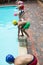 Children preparing to dive in pool