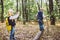 Children preschoolers Caucasian brother and sister take pictures of each other on mobile phone camera in forest park