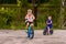 Children preschoolers ride a two-wheeled bike on the paved area in the summer. Children and sports