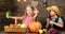 Children presenting farm harvest wooden background. Siblings having fun. Farm market. Farming teaches kids where their