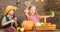 Children presenting farm harvest wooden background. Siblings having fun. Farm market. Farming teaches kids where their