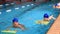 Children of primary school age are trained in swimming pool.