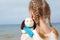 Children psychology. The little beautiful girl embraces an amusing dog - toy. Favorite soft toy.