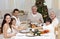 Children pulling a Christmas cracker at home