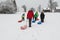 Children pulling sled on snowy hill