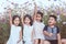 Children raise hands and playing together in the cosmos flower