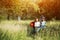 Children ran and laugh while their mother on wheelchair and father are running after them