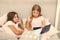 Children read book in bed. Stories every kid should read. Family tradition. Girls best friends read fairy tale before