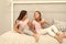 Children relax and having fun in evening. Sisters leisure. Girls in cute pajamas spend time together in bedroom. Sisters