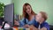 Children remote education, schoolboy with down syndrome studies with female pedagogue during home lesson sitting at the