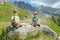 Children rest on big stone in mountains