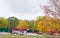 Children ride bicycles, skateboards, scooters in roller park in autumn