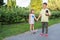 Children ride on a skateboard and listen to music. Outdoor games