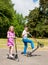 Children riding scooters in a park