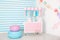 Children room with blue stripe background. candy stall photo zone with big macaroons, sweets and marshmallows. trolley with ice cr