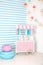 Children room with blue stripe background. candy stall photo zone with big macaroons, sweets and marshmallows. trolley with ice cr