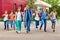 Children with rucksacks near school walking